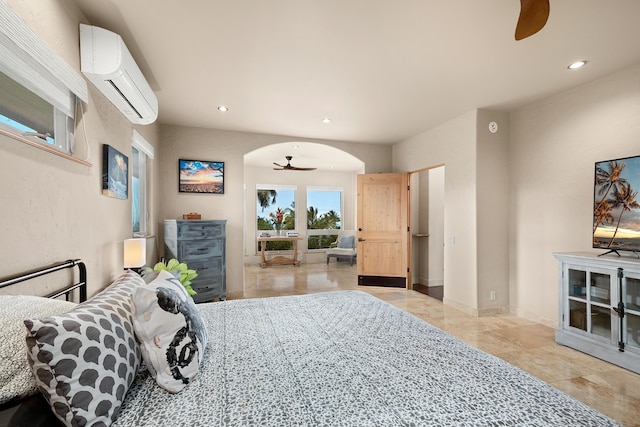 bedroom with arched walkways, recessed lighting, baseboards, access to outside, and a wall mounted AC