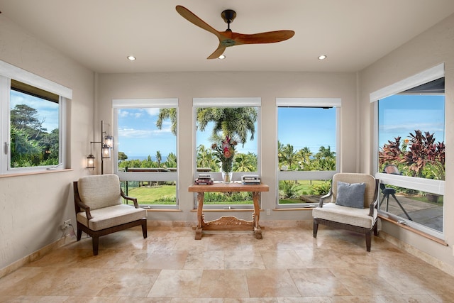 sunroom featuring ceiling fan and plenty of natural light