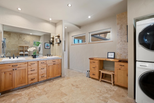 interior space with recessed lighting, stacked washer and clothes dryer, a sink, and double vanity