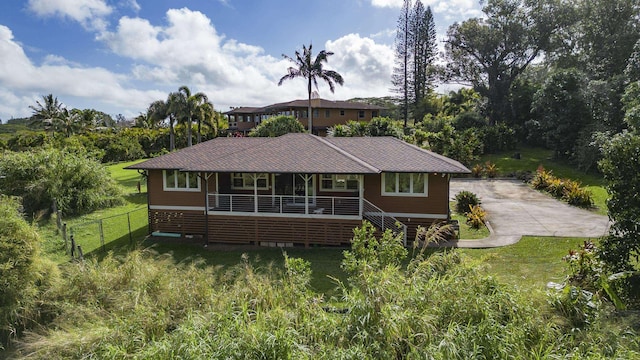 ranch-style house with covered porch, fence, stairs, crawl space, and a front lawn