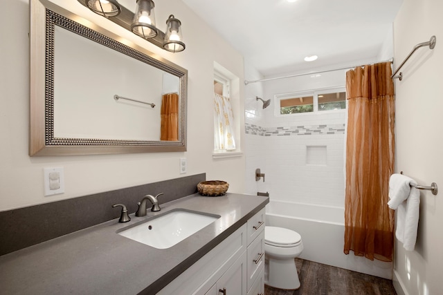 full bathroom featuring shower / tub combo with curtain, vanity, toilet, and wood finished floors