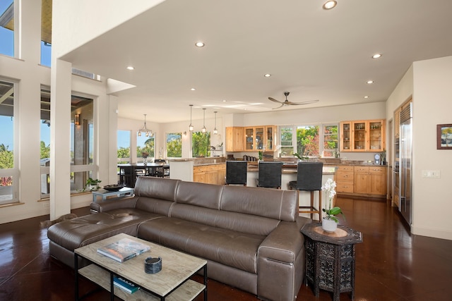 living room with recessed lighting, ceiling fan, and baseboards