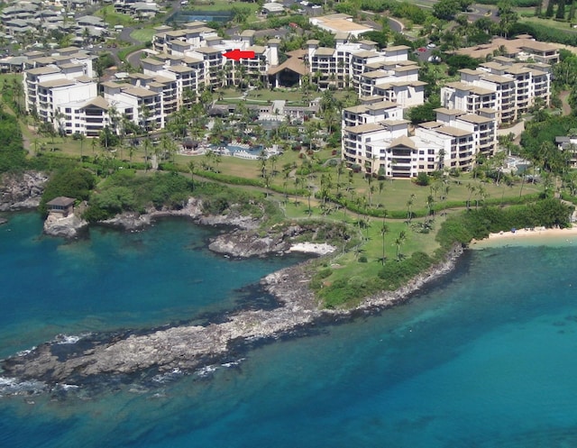 birds eye view of property featuring a beach view and a water view