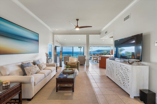 living room featuring light tile patterned flooring, visible vents, crown molding, and ceiling fan