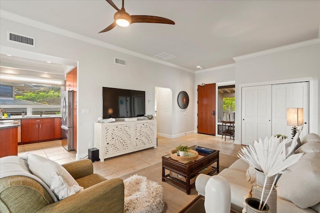 living area with light tile patterned floors, visible vents, and ceiling fan