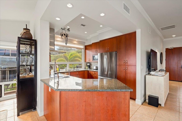 kitchen featuring visible vents, dark stone countertops, stainless steel appliances, and a sink