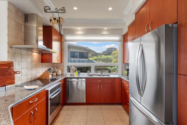 kitchen featuring a sink, tasteful backsplash, stainless steel appliances, wall chimney exhaust hood, and light tile patterned floors