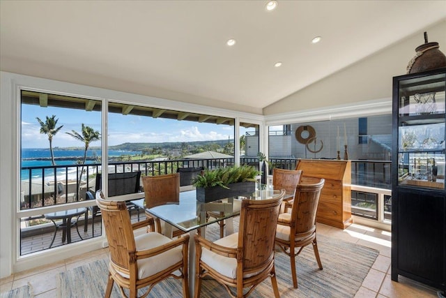 sunroom / solarium featuring lofted ceiling, plenty of natural light, and a water view