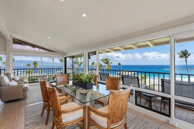 sunroom / solarium with lofted ceiling and a water view