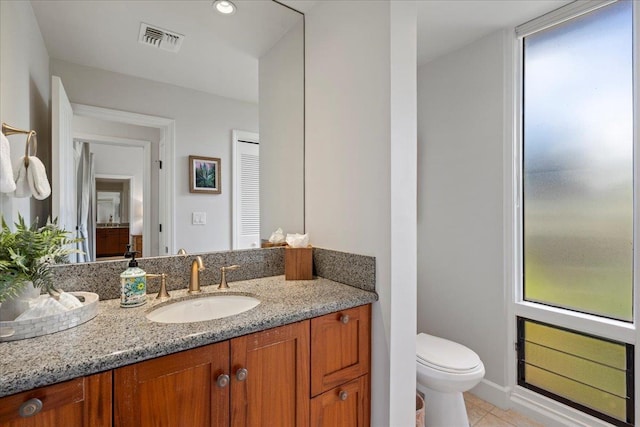 bathroom featuring visible vents, toilet, recessed lighting, tile patterned flooring, and vanity