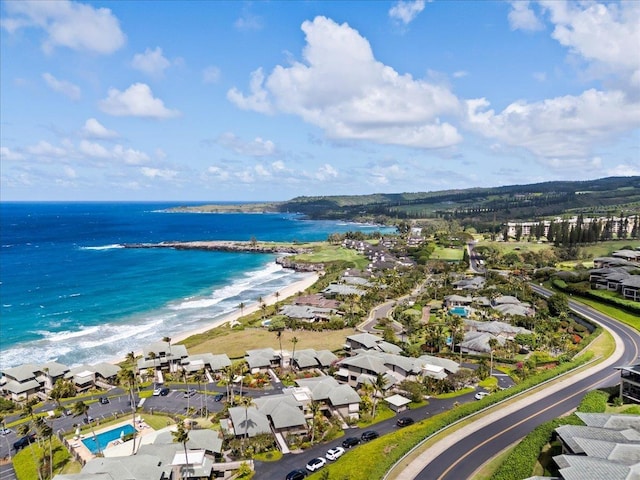 drone / aerial view with a water view and a beach view