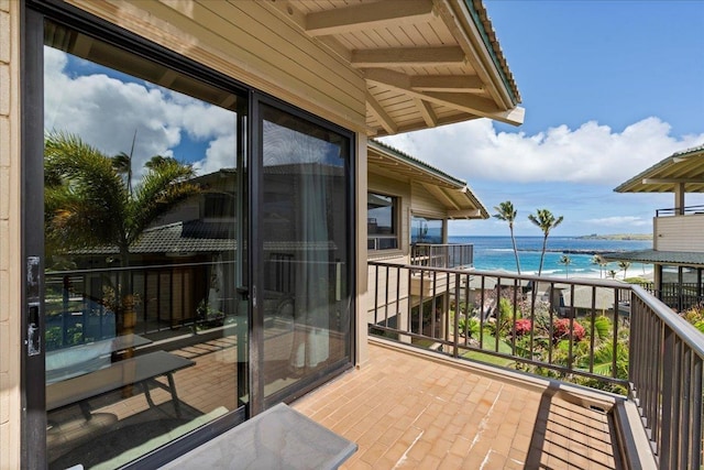 balcony featuring a water view and a beach view