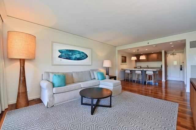 living room featuring hardwood / wood-style floors and ornamental molding