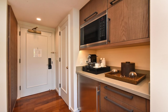 interior space featuring stainless steel microwave and dark hardwood / wood-style floors