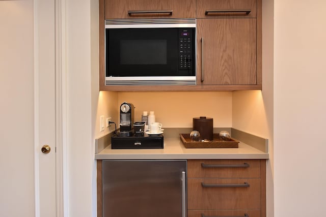 bar with stainless steel refrigerator and built in microwave