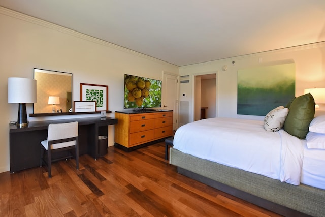 bedroom with ornamental molding and dark wood-type flooring