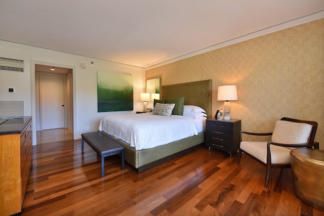 bedroom featuring dark hardwood / wood-style flooring and crown molding