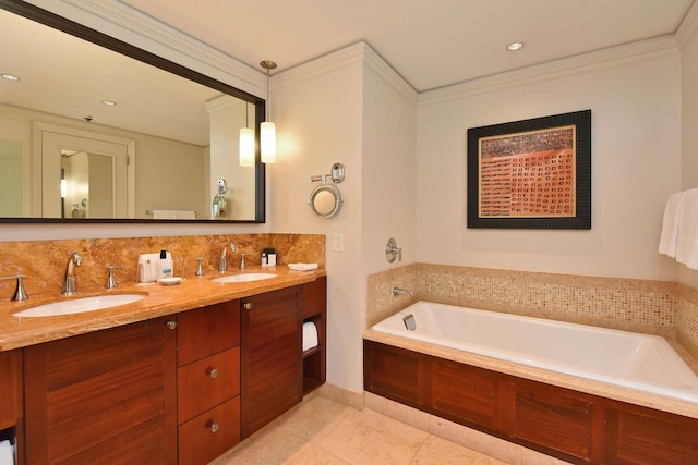 bathroom featuring a washtub, ornamental molding, and vanity