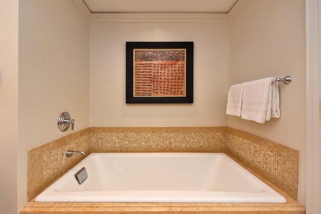 bathroom featuring crown molding and tiled bath