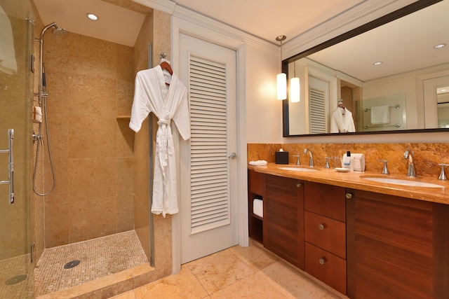 bathroom with a tile shower, vanity, tasteful backsplash, and crown molding