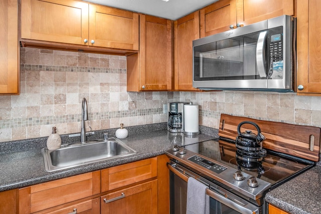 kitchen featuring backsplash, sink, and range with electric stovetop