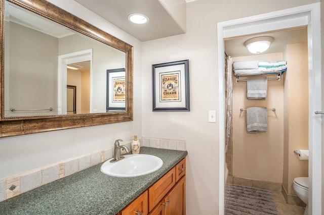 bathroom with tile flooring, vanity, and toilet