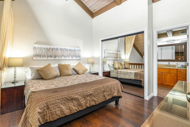 bedroom with high vaulted ceiling, dark wood-type flooring, sink, and a closet