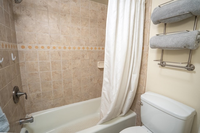 bathroom with shower / bath combination with curtain and toilet