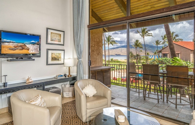 living area with a water view and wooden ceiling