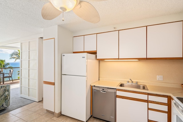 kitchen with stainless steel dishwasher, ceiling fan, sink, white cabinets, and white fridge