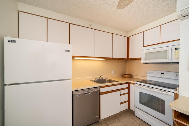 kitchen featuring white cabinets, a textured ceiling, white appliances, and sink