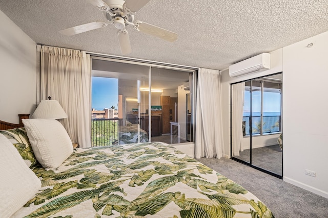 carpeted bedroom featuring access to exterior, ceiling fan, a wall mounted air conditioner, a textured ceiling, and a closet