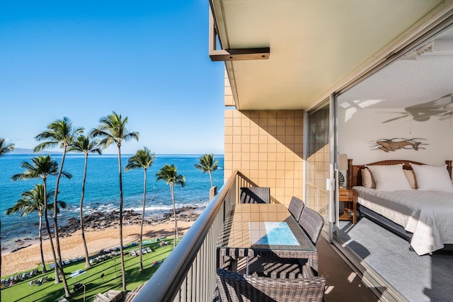 balcony featuring a water view and a view of the beach