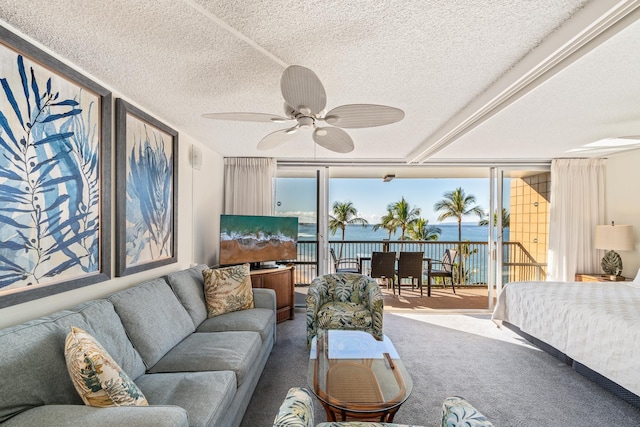 carpeted bedroom featuring access to exterior, ceiling fan, and a textured ceiling