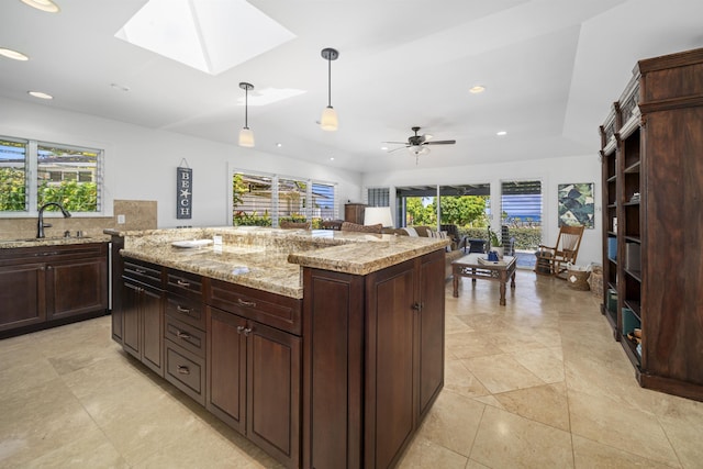 20 Hui Rd I 41, Lahaina, HI 96761 - kitchen with recessed lighting, a skylight, hanging light fixtures, light stone counters, and a center island