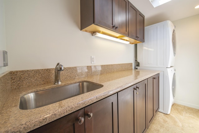 20 Hui Rd I 41, Lahaina, HI 96761 - kitchen featuring stacked washing machine and dryer, dark brown cabinets, and light stone counters