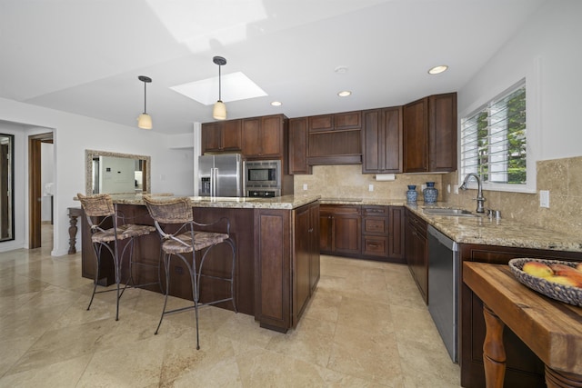 20 Hui Rd I 41, Lahaina, HI 96761 - kitchen with stainless steel appliances, a skylight, backsplash, hanging light fixtures, and a center island