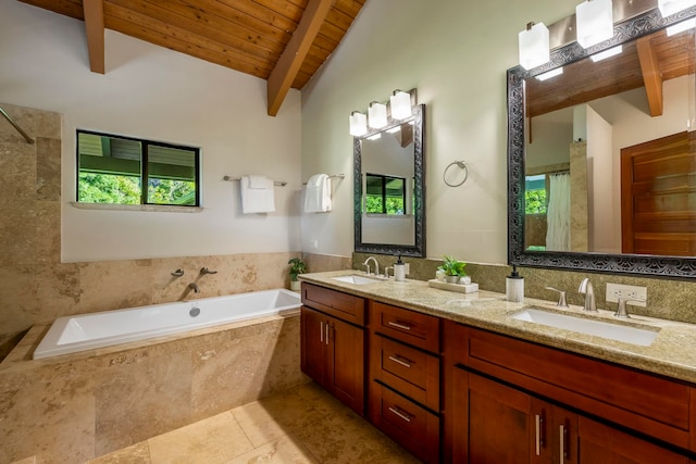 bathroom with vaulted ceiling with beams, wooden ceiling, vanity with extensive cabinet space, a relaxing tiled bath, and dual sinks