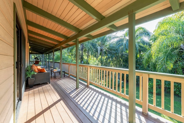 wooden deck with a lawn