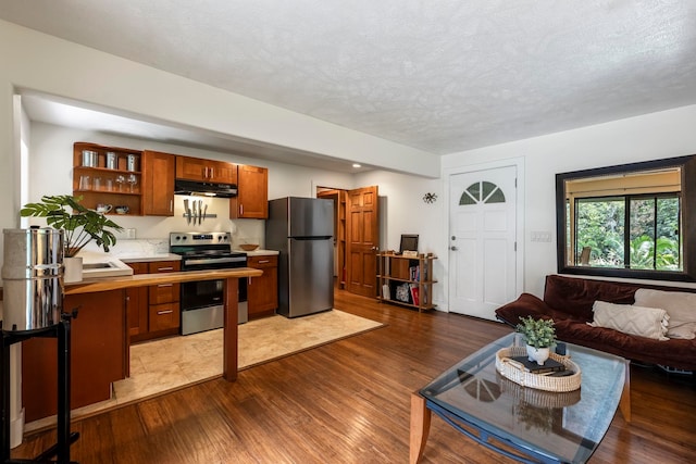 living room with sink, dark wood-type flooring, and a textured ceiling