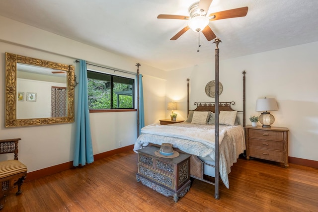 bedroom with ceiling fan and dark wood-type flooring