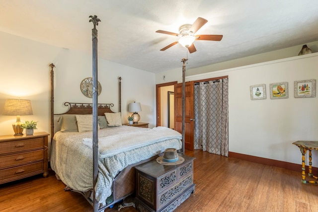 bedroom featuring ceiling fan and dark wood-type flooring