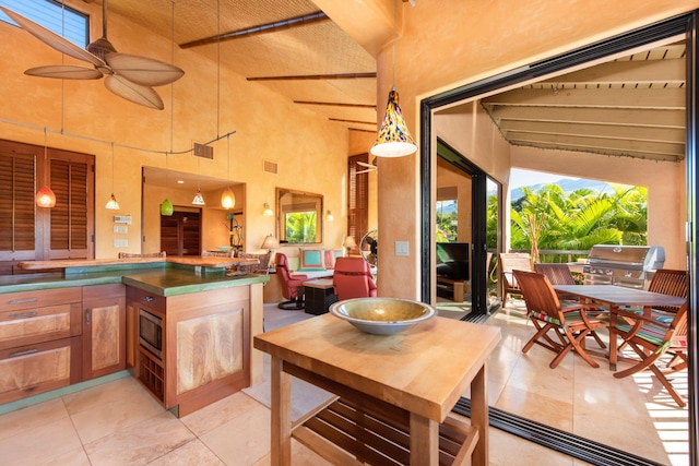 view of patio with an outdoor kitchen, a grill, and ceiling fan