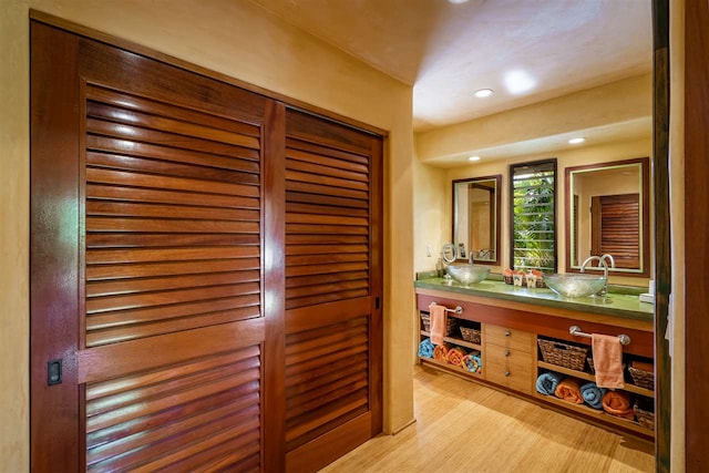 bathroom with vanity and wood-type flooring