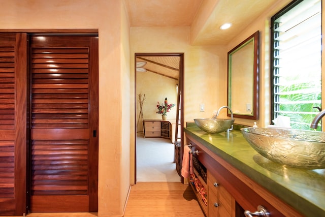 hallway with sink and light hardwood / wood-style flooring