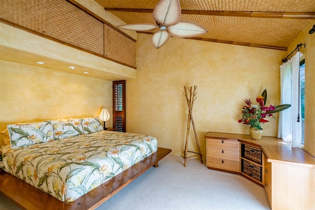 carpeted bedroom featuring high vaulted ceiling and multiple windows