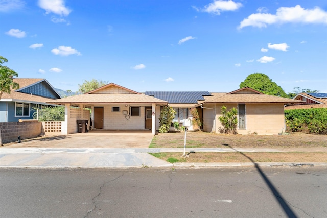 single story home with a carport and solar panels