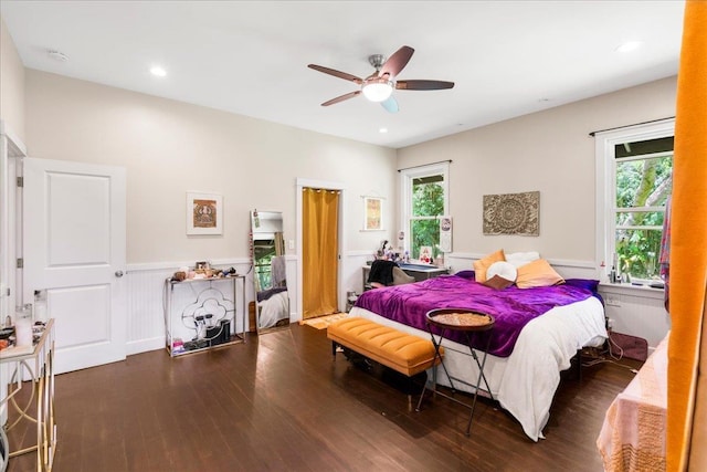 bedroom featuring a ceiling fan, recessed lighting, a wainscoted wall, and wood finished floors