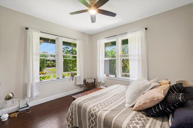 bedroom with wood finished floors, baseboards, and ceiling fan
