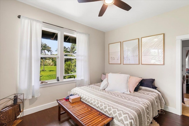 bedroom featuring dark wood-style flooring, baseboards, and ceiling fan
